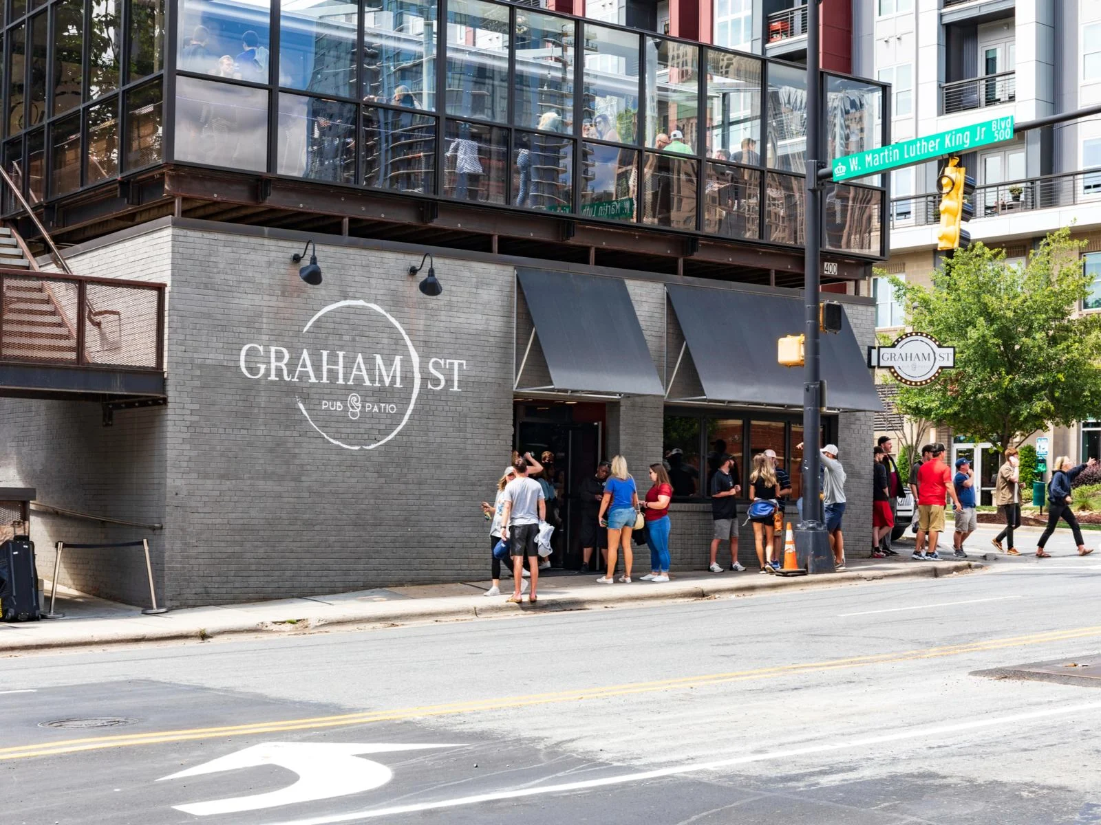 Young people line up for admission to the busy Graham St. Pub for a piece titled the best things to do in Charlotte NC