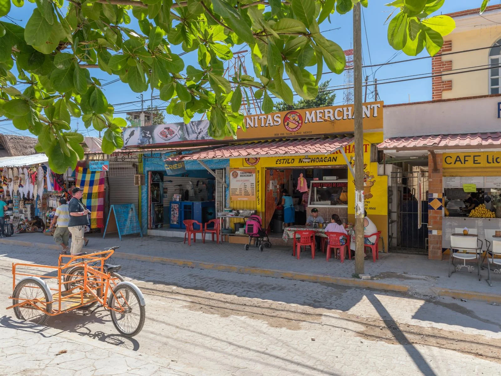 Downtown market with a bike and sandy brick streets on a nice day during the least busy time to visit Tulum