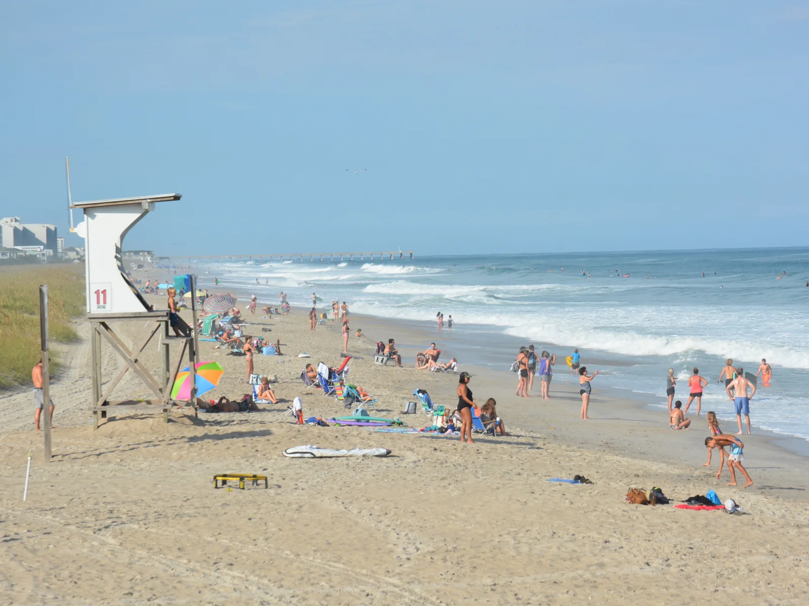 Many visitors enjoying the wavy summer day at Carolina Beach in North Carolina, one of the best beaches on the East Coast