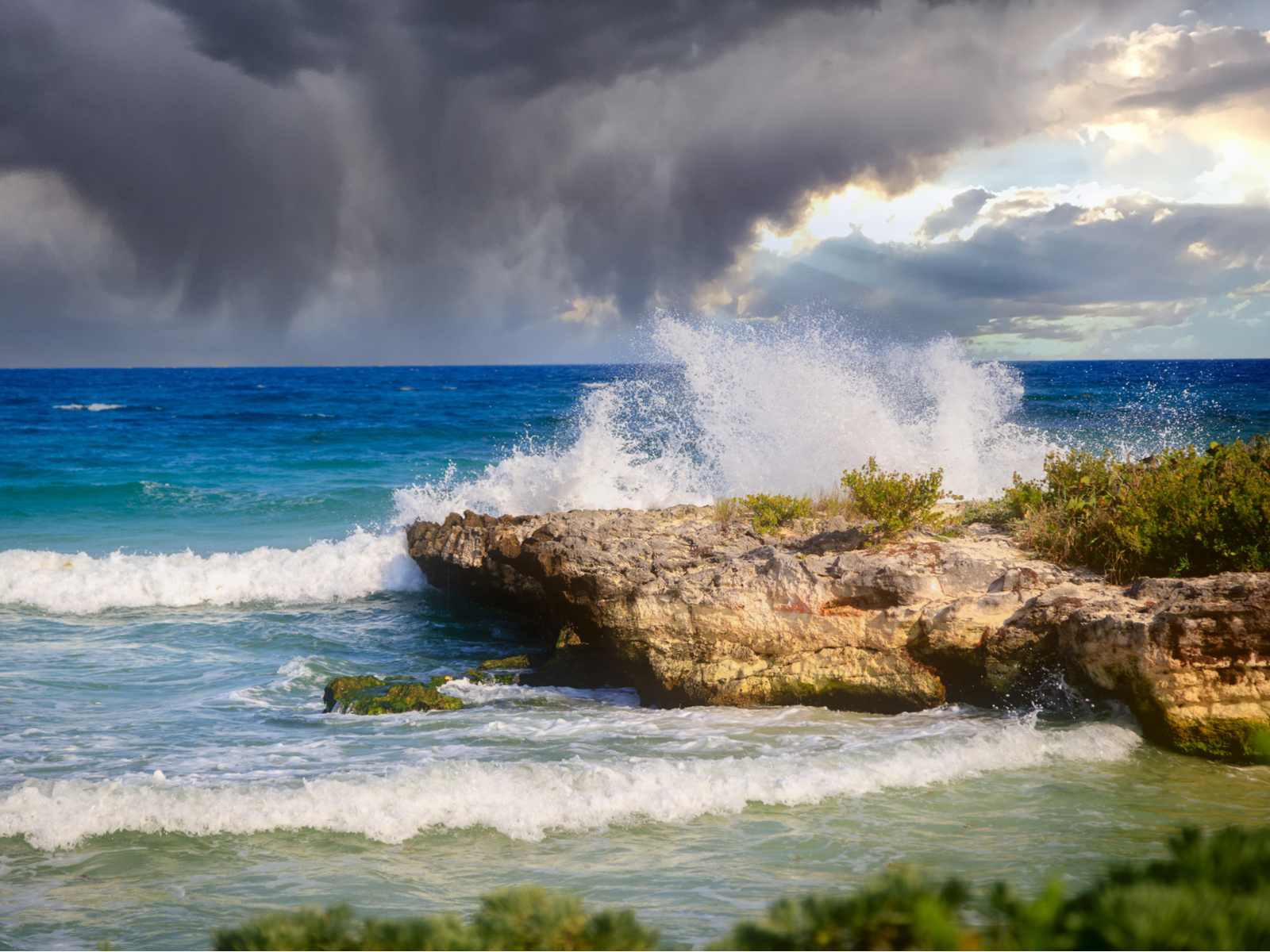 Storm clouds rolling in of the rocky coast during the best time to visit Tulum