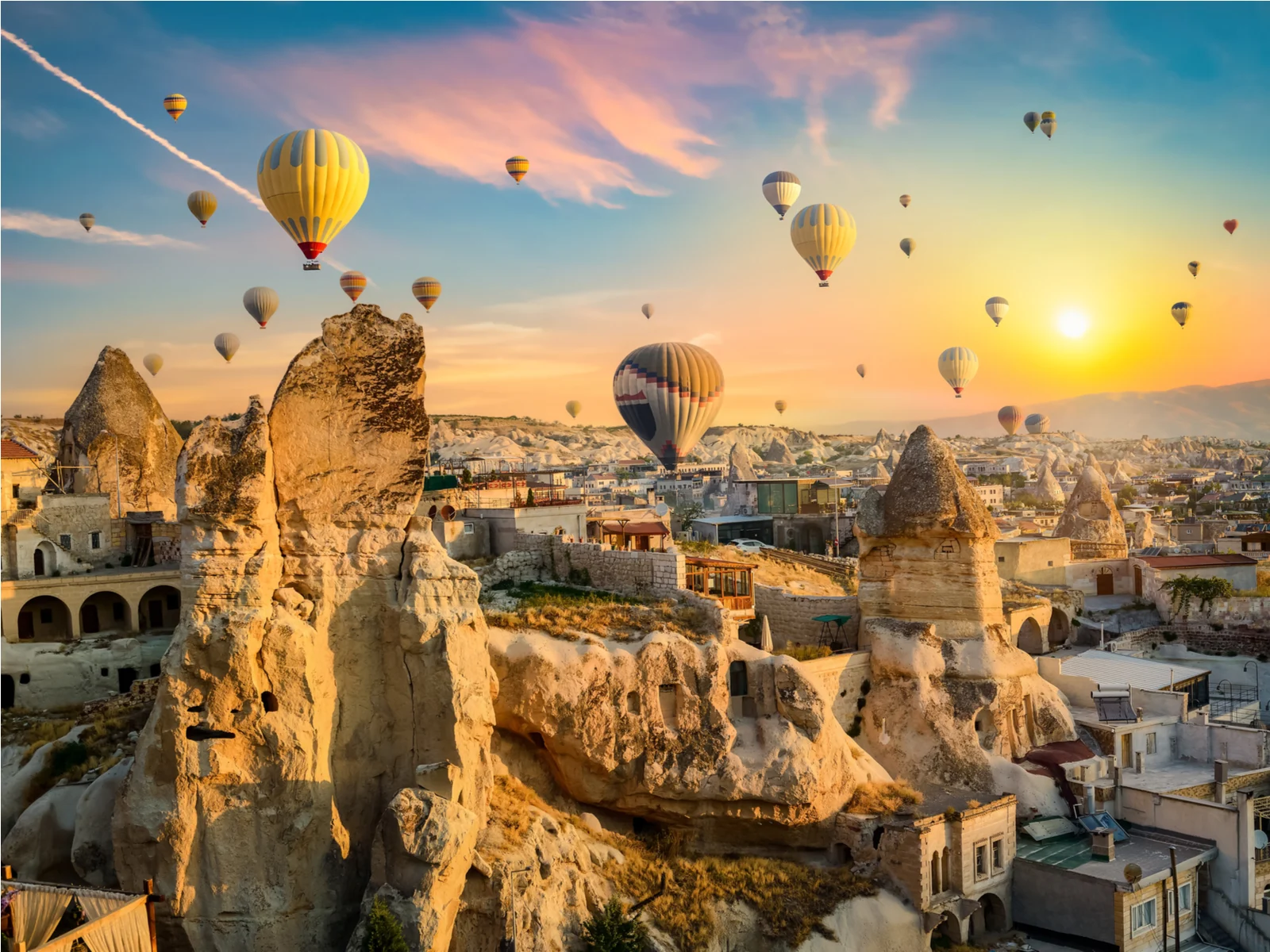 Hot air balloons at sunset in the Goreme village during the best time to visit Turkey