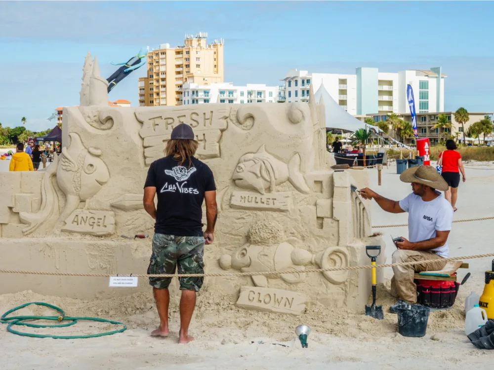 Two artist doing a sand sculpting exhibition at the Treasure Island Beach, one of the best beaches in the US