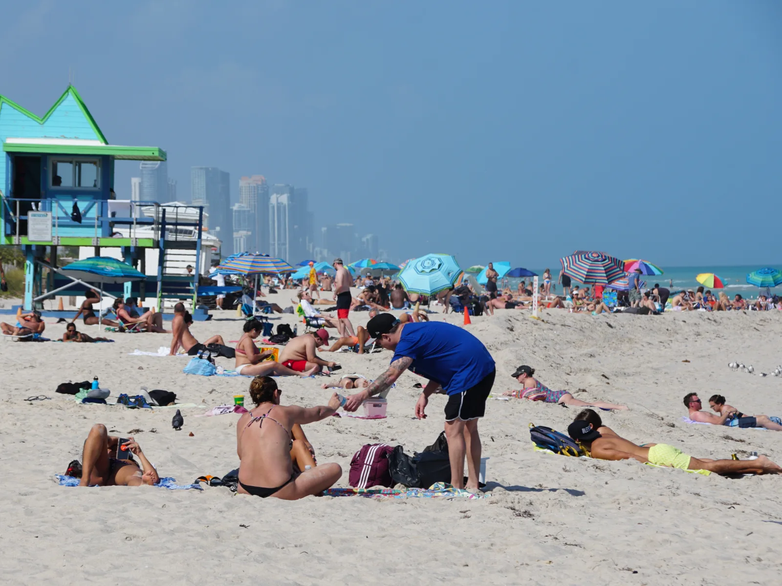 Visitors on a crowded Miami beach on a hot day for a piece on the best beaches on the East Coast
