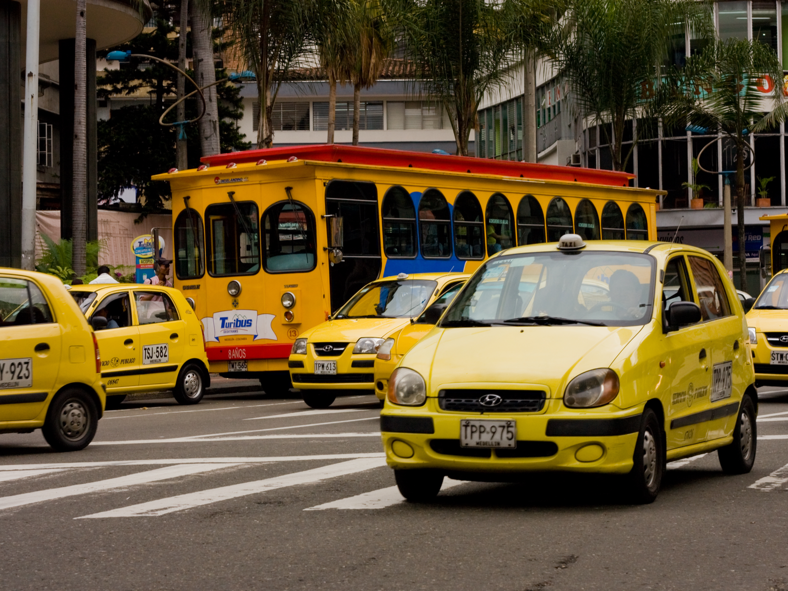 Yellow cabs on the street in Medellin for a post titled Is Colombia Safe