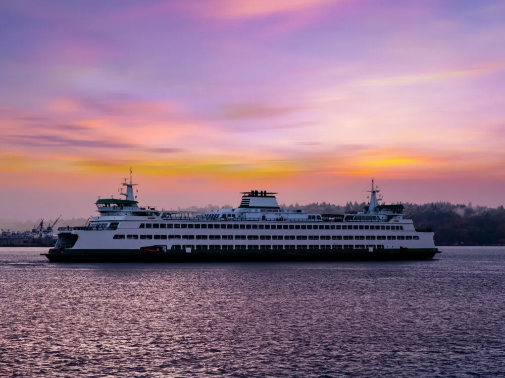 A ferry cruising in Elliot Bay under a crimson sunset is one of the best things to do in Washington, D.C.