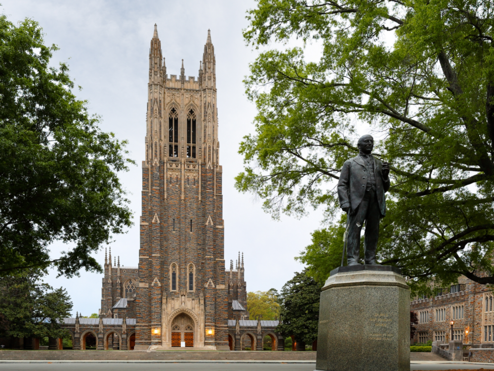 The historic and towering chapel at Duke University in North Carolina, one of the most beautiful college campuses, fronting the statue of Benjamin Duke