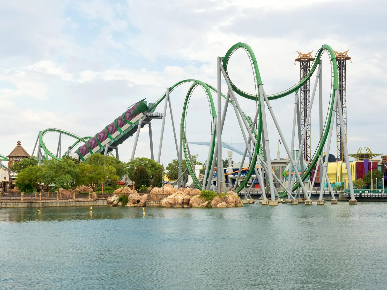 The green Hulk Rollercoaster crossing a pool at Universal Studios in Orlando, Florida, one of the best roller coaster parks in the US