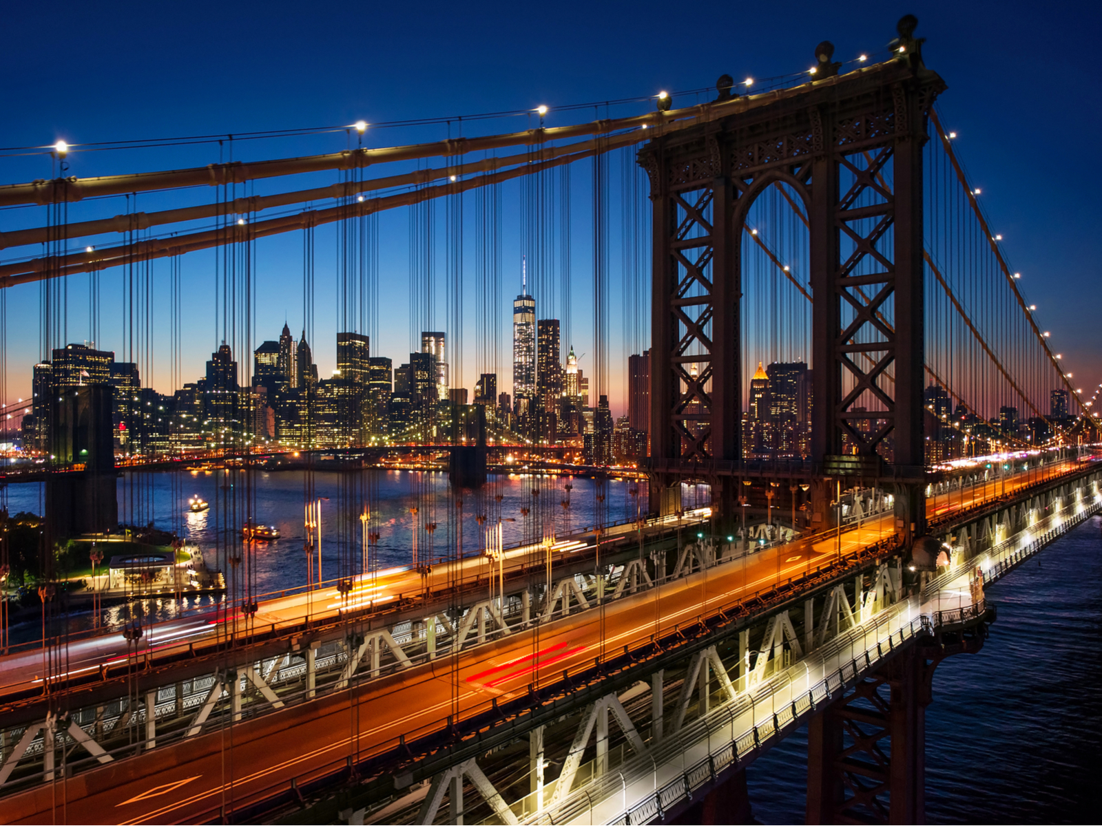 Beautiful night shot of the Brooklyn Bridge pictured during the best time to visit New York City