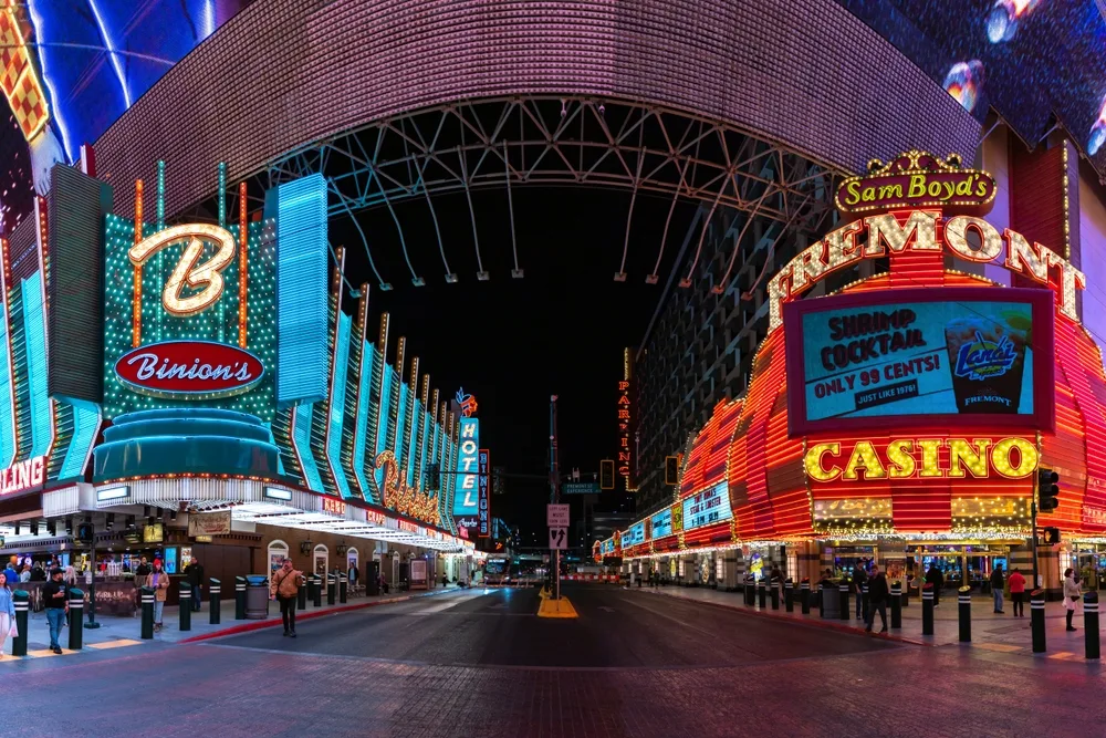 Photo taken at night of Fremont Street with its cool covering and neon signs on either side of the covered street