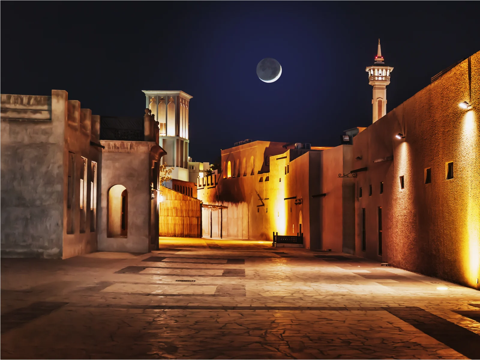For a piece titled Is Dubai Safe, the old arab city pictured at night with the moon in full view