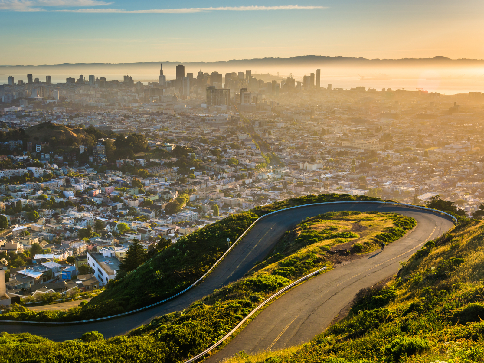 Curvy road with downtown San Fran at sunrise