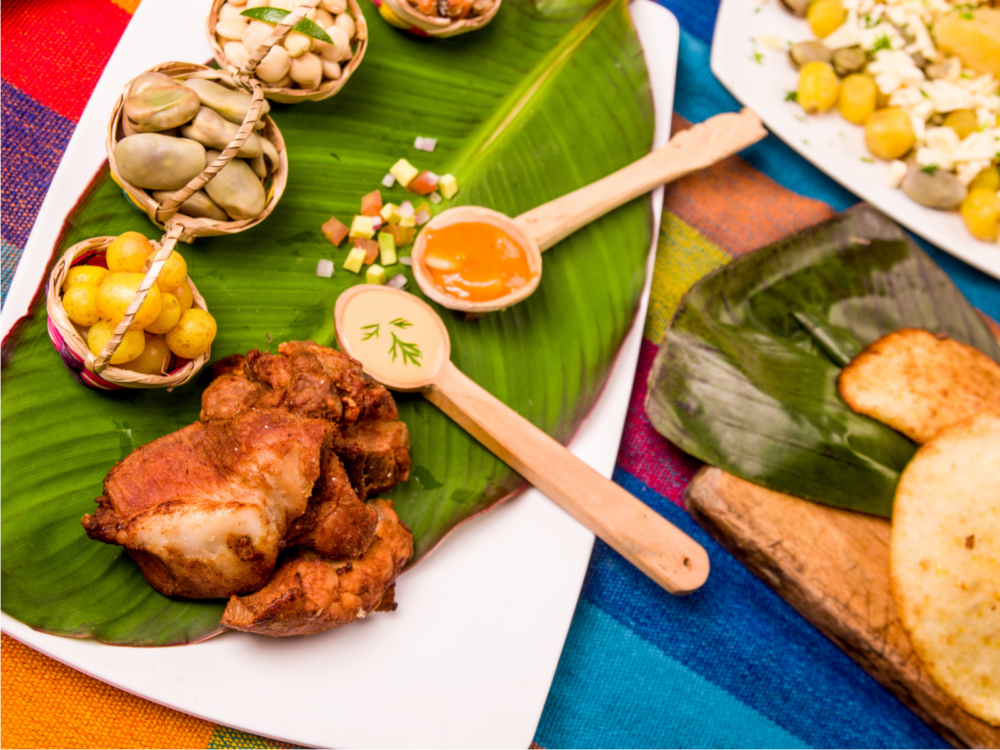 Traditional ecuadoian dishes with pork and chicken on a wooden serving plate