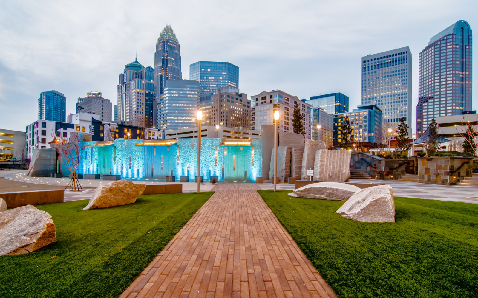 Downtown skyline with a blue wall in a park, one of the best things to do in Charlotte NC, on a cloudy day