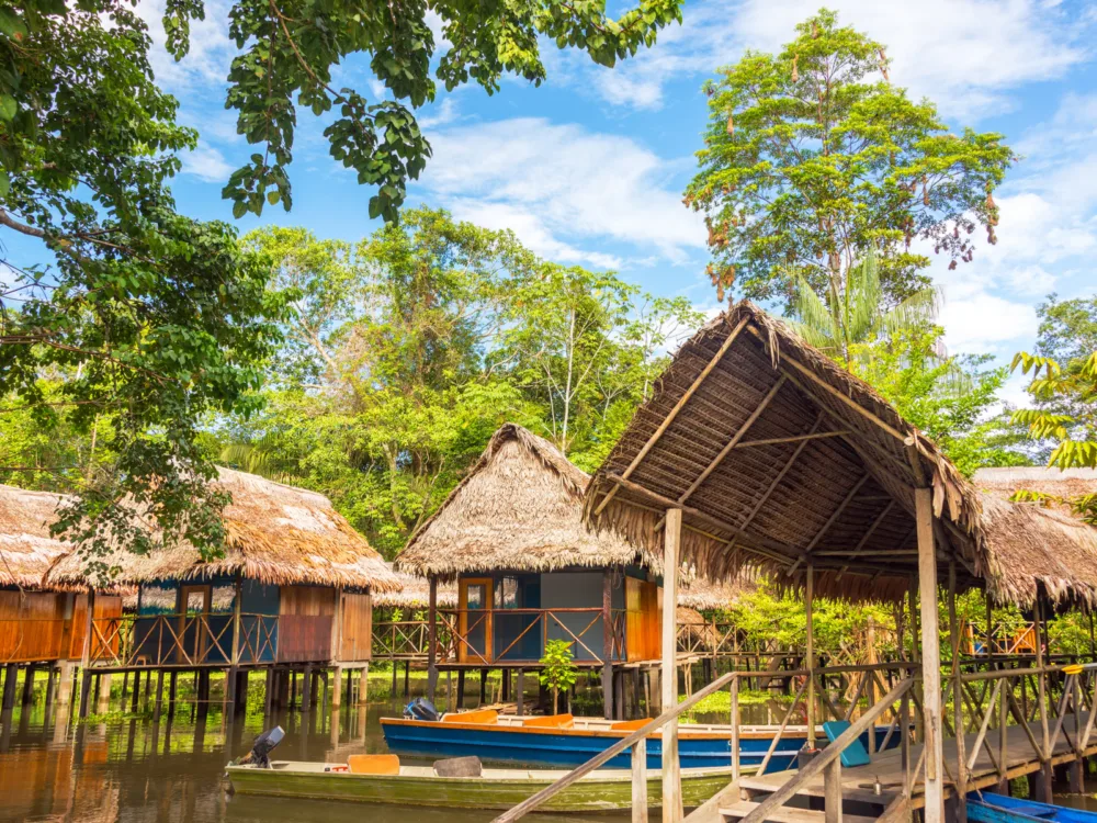 Jungle shacks in Iquitos in the rainforest pictured during the best time to visit Peru