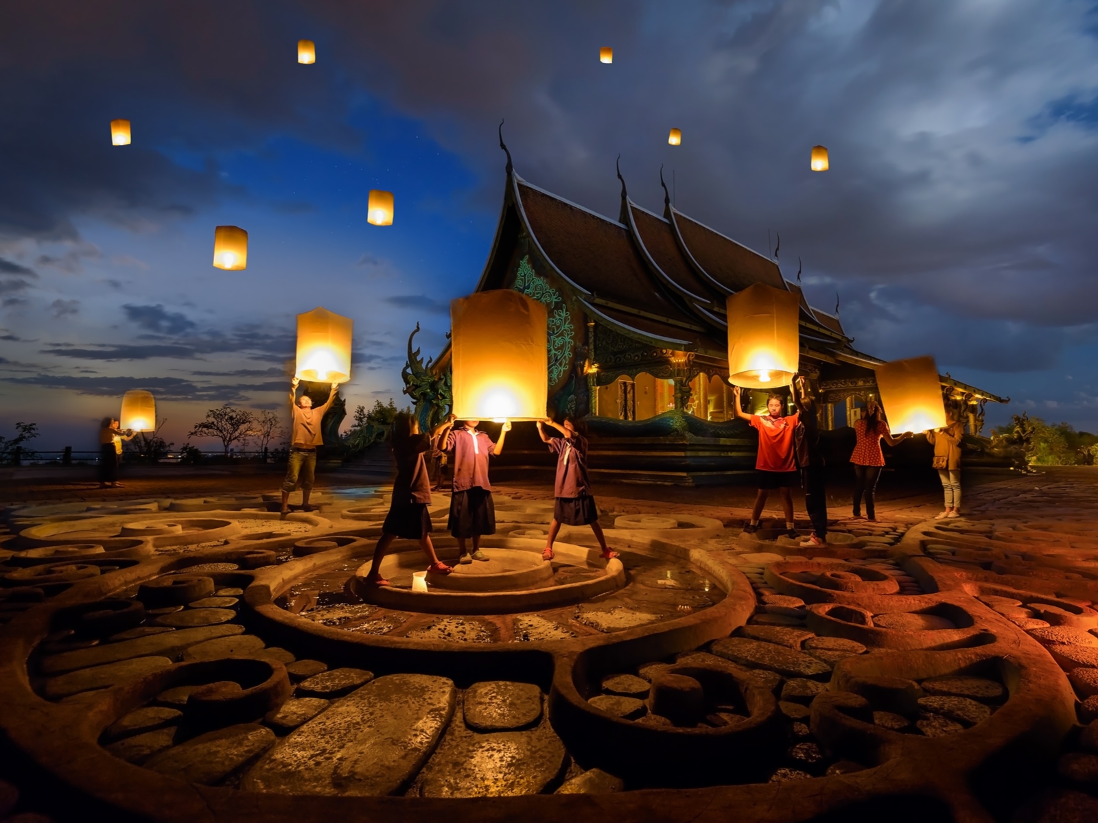People launching floating paper lamps at the Yeepeng Festival during the best time to go to Thailand