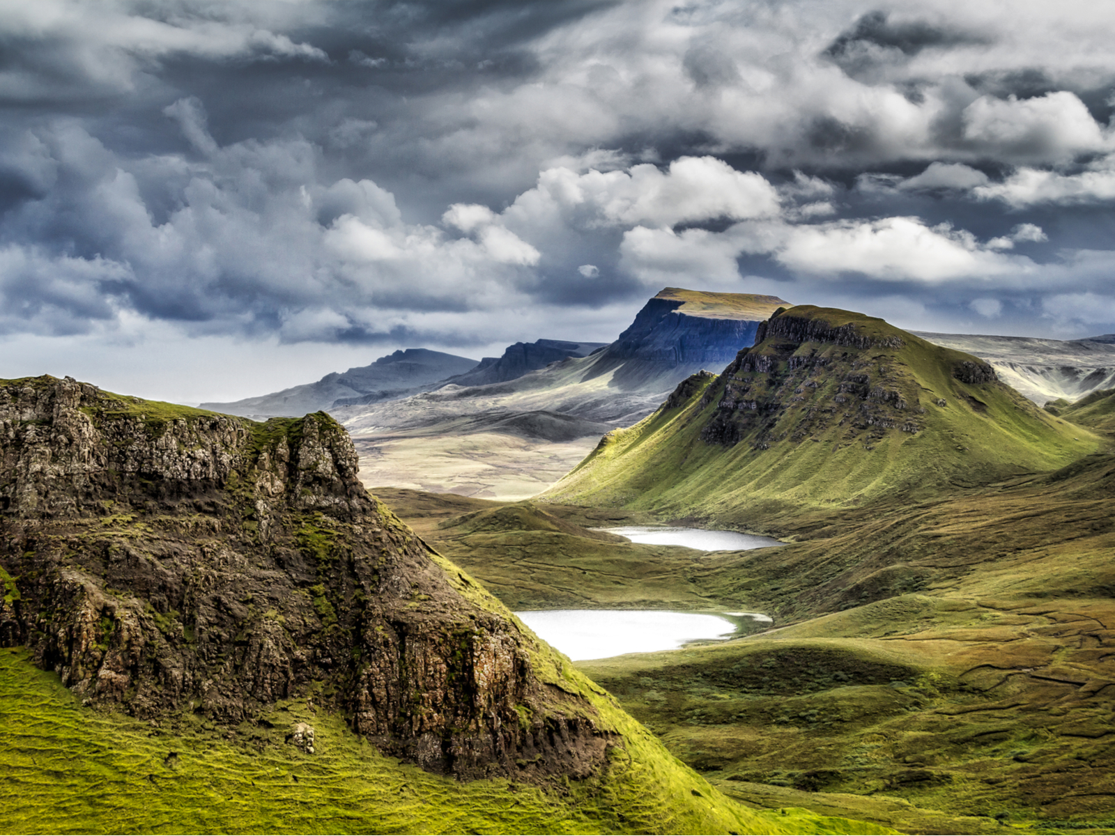 Highland Mountains pictured during the best time to visit Scotland with warm weather and few clouds in the sky