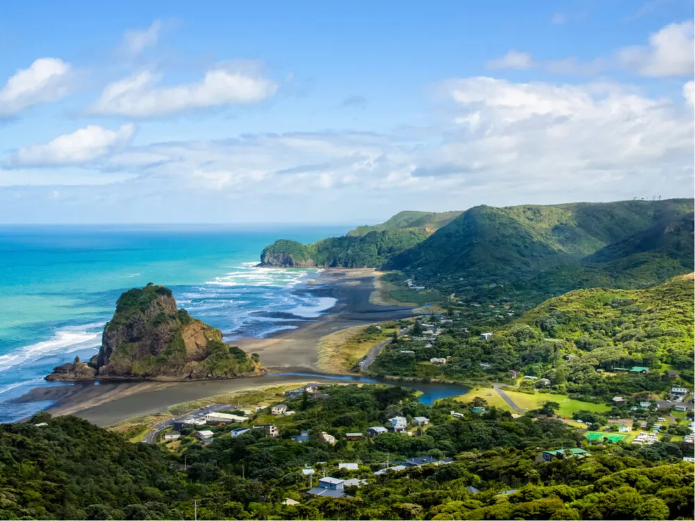 Piha Beach as seen from a hilltop pictured during the best time to visit New Zealand