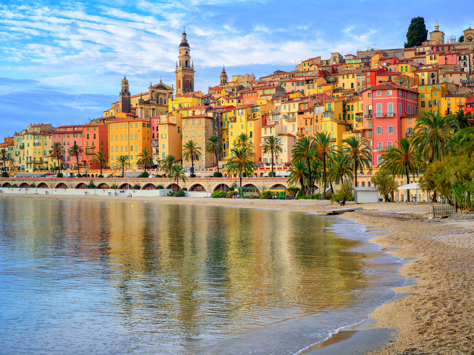 Sandy beach pictured during the worst time to visit France in the old town of Menton