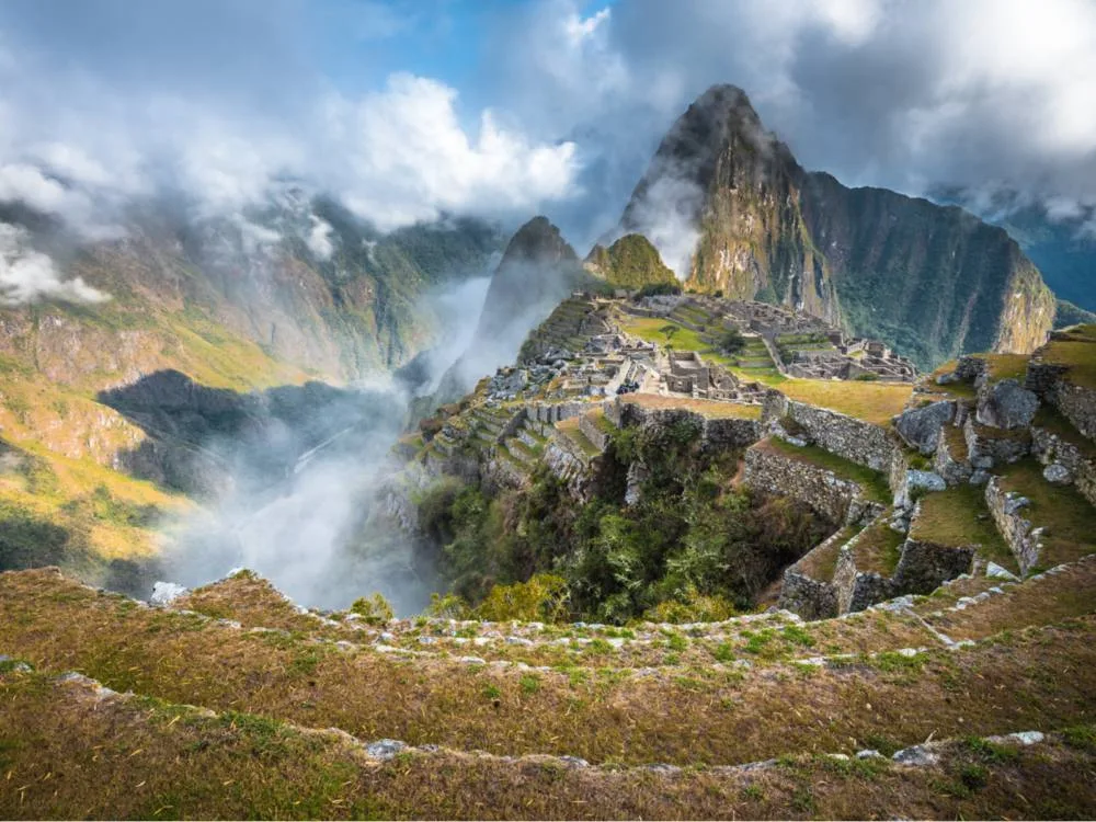 Rain and clouds pictured over the ruins during the worst time to visit Machu Picchu