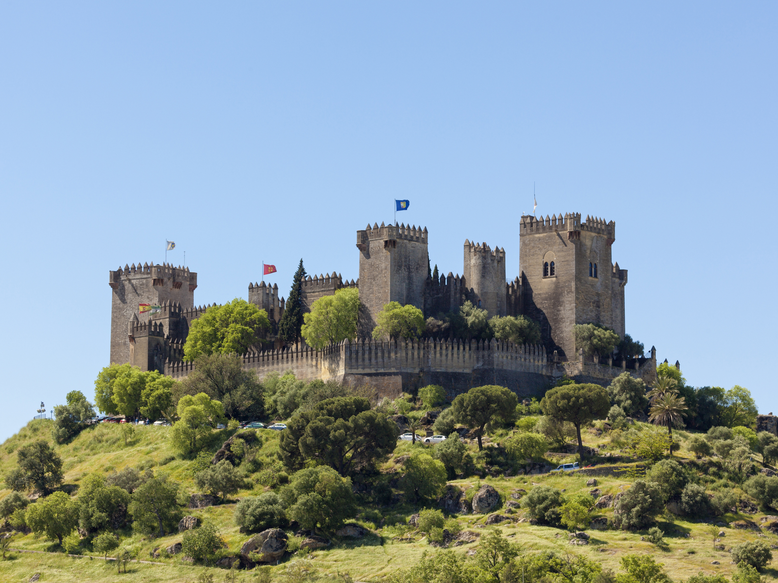 An old fortified medieval fortress on top of a hill, Castillo Almodovar del Rio in Spain, is one of the Game of Thrones filming locations you can visit in real life