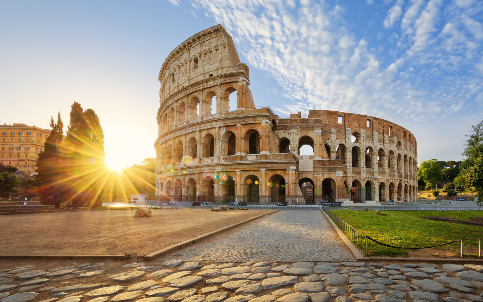 Photo of the Colosseum in Italy pictured at sunrise for a piece on where to stay in Rome