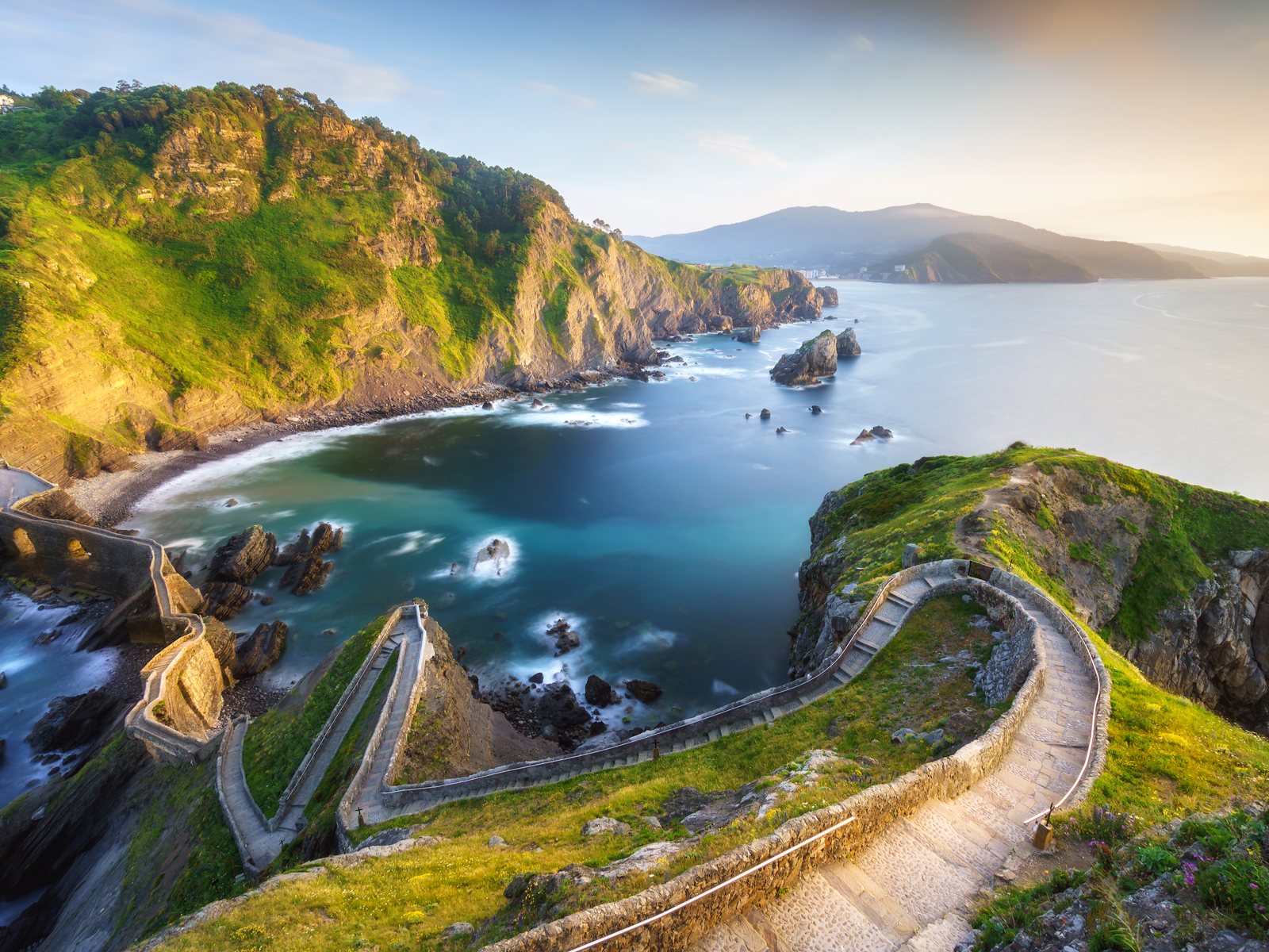 Narrow stairs on a coastal mountain at Gaztelugatxe in Spain, one of the Game of Thrones filming locations you can visit
