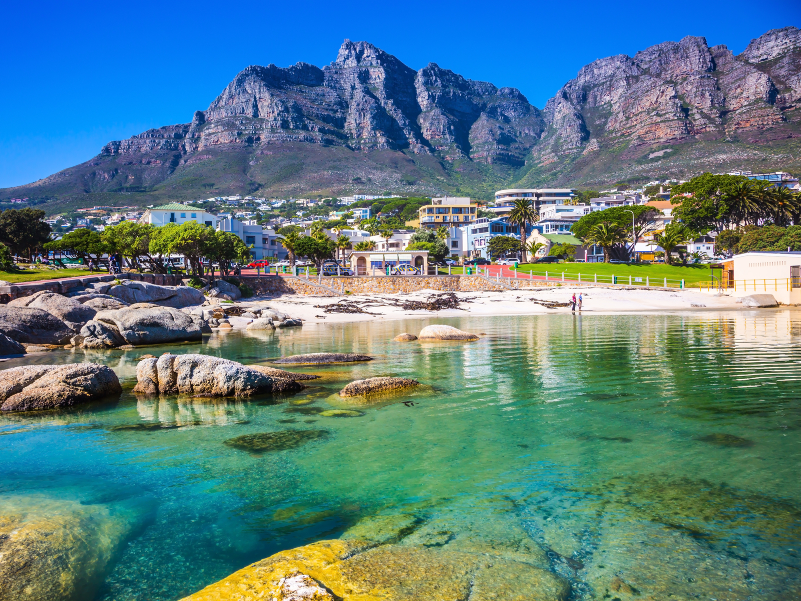 Panoramic view of Cape Town from the bank of a river looking toward the city during the cheapest time to visit South Africa