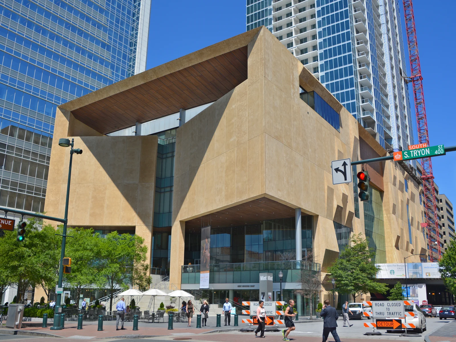people casually walking in front of mint museum uptown, one of the best things to do in charlotte, nc, during a clear day