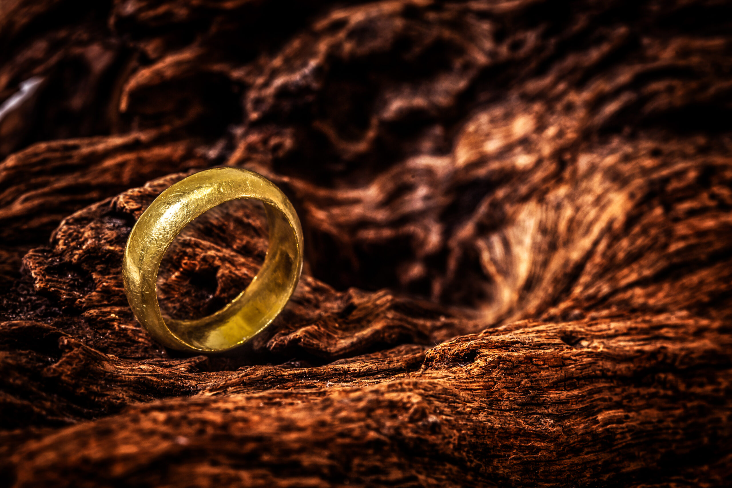 Old golden ring in dark background, one of Lord of the Rings filming locations