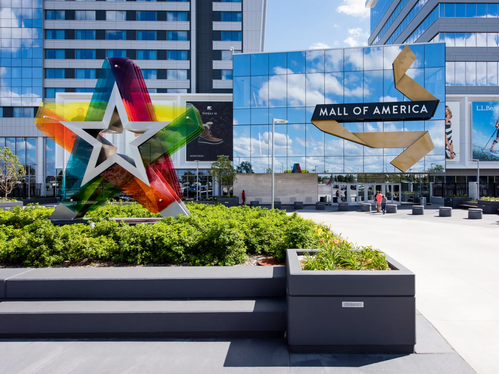 Front entrance to the Mall of America with glass walls and a start in multiple colors