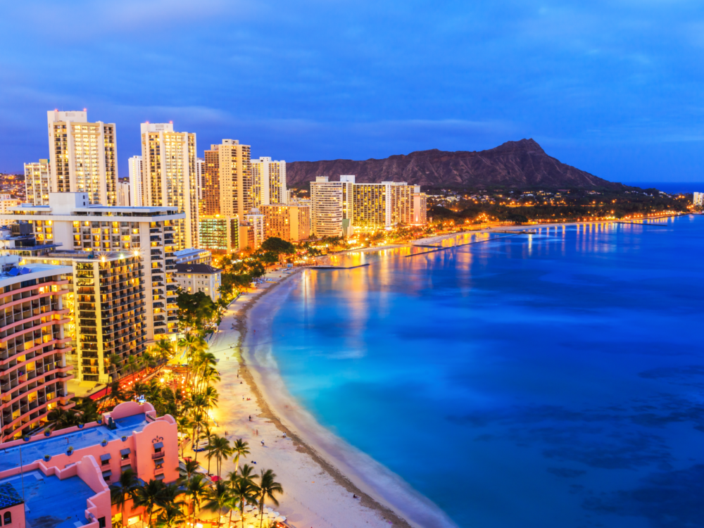 The skyline of Honolulu against the calm Waikiki Beach with Diamond Head volcano, a progressive city in Hawaii and one of the most beautiful cities in the US