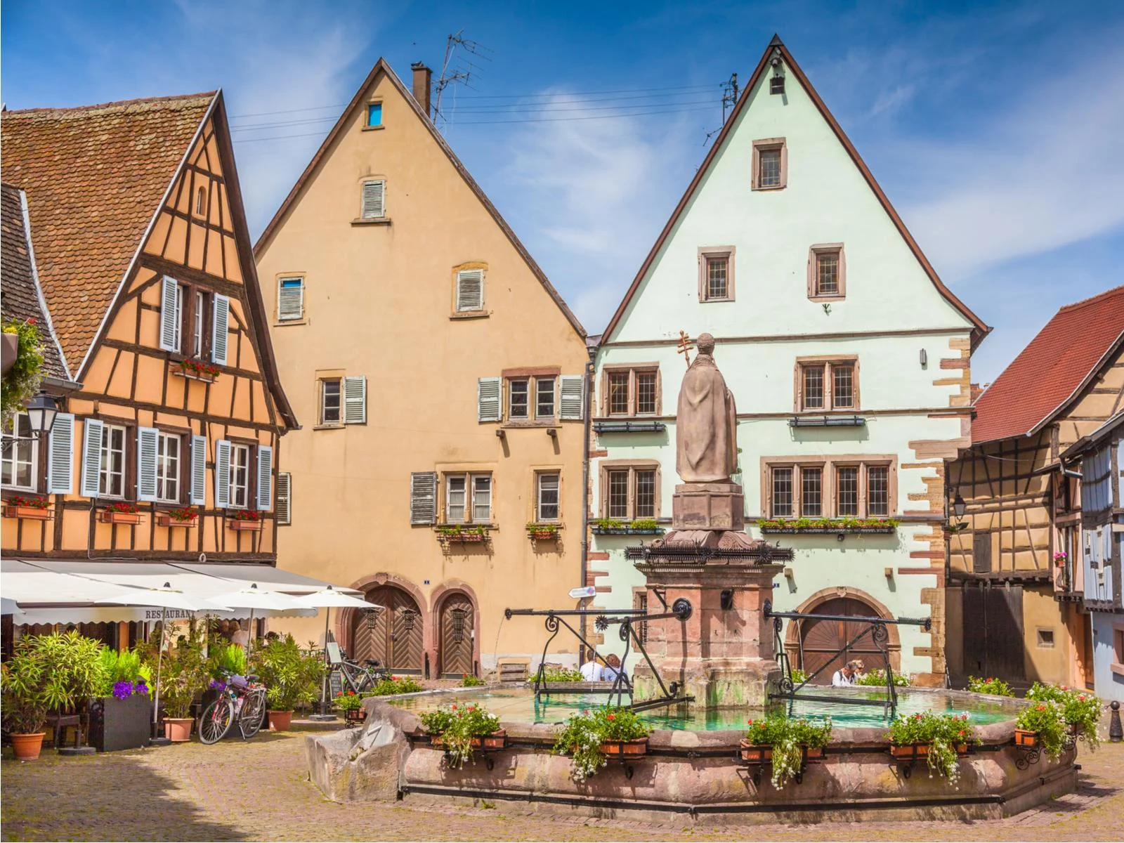 Awesome view of the unique and historic town square in Eguisheim during the best time to visit France