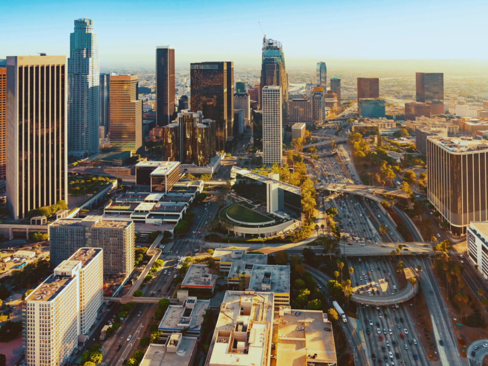 Aerial view of downtown, one of the best places to stay in Los Angeles, on a somewhat hazy day with lots of tall buildings in the photo