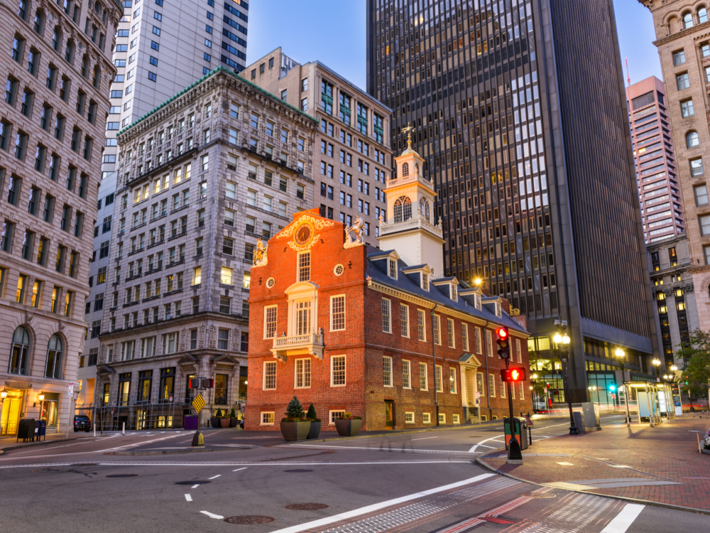 The vibrant Old State House at the foot of other tall buildings amidst the lonely city of Boston in Massachusetts, considered one of the most beautiful cities in the US