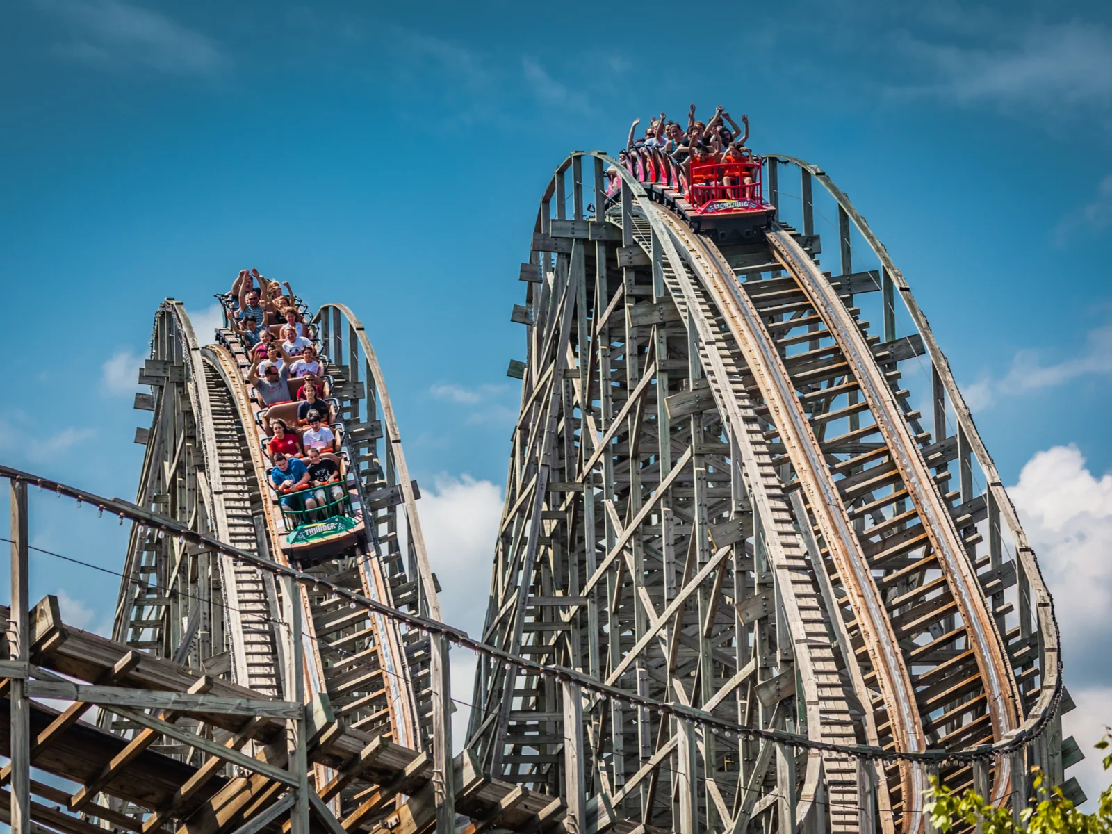 Children and Adults are ecstatic as they ride the double-track dueling wooden Lightning Racer at Hersheypark in Hershey, Pennsylvania, one of the best roller coaster parks in the US