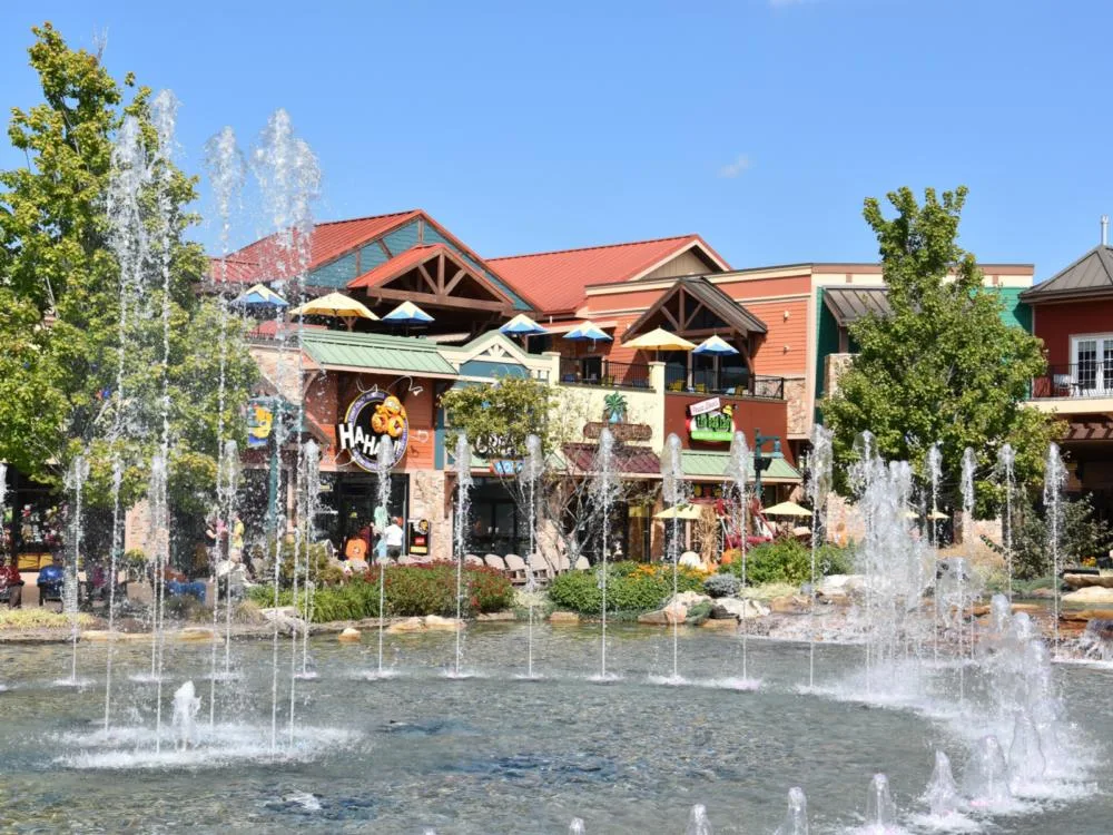The Island shopping center, one of the best things to do in Pigeon Forge, pictured in the Summer with a fountain spraying water
