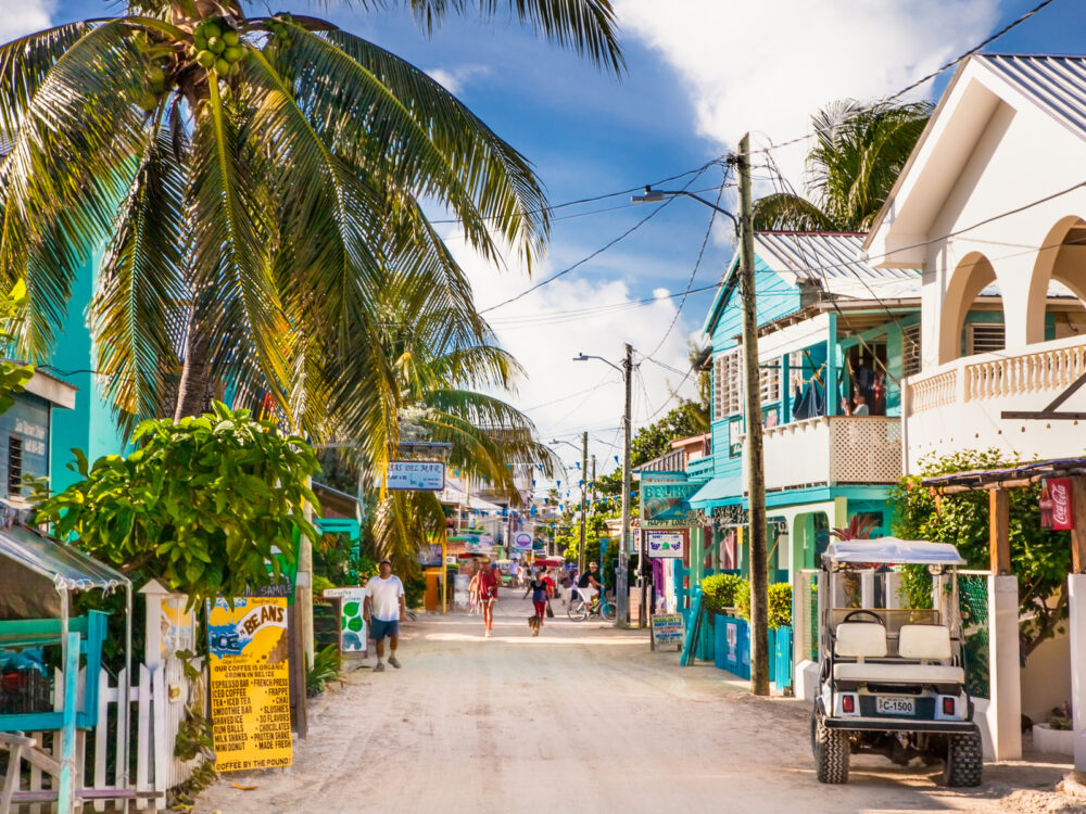 Image of Caye Caulker in the Summer with people walking down a long street