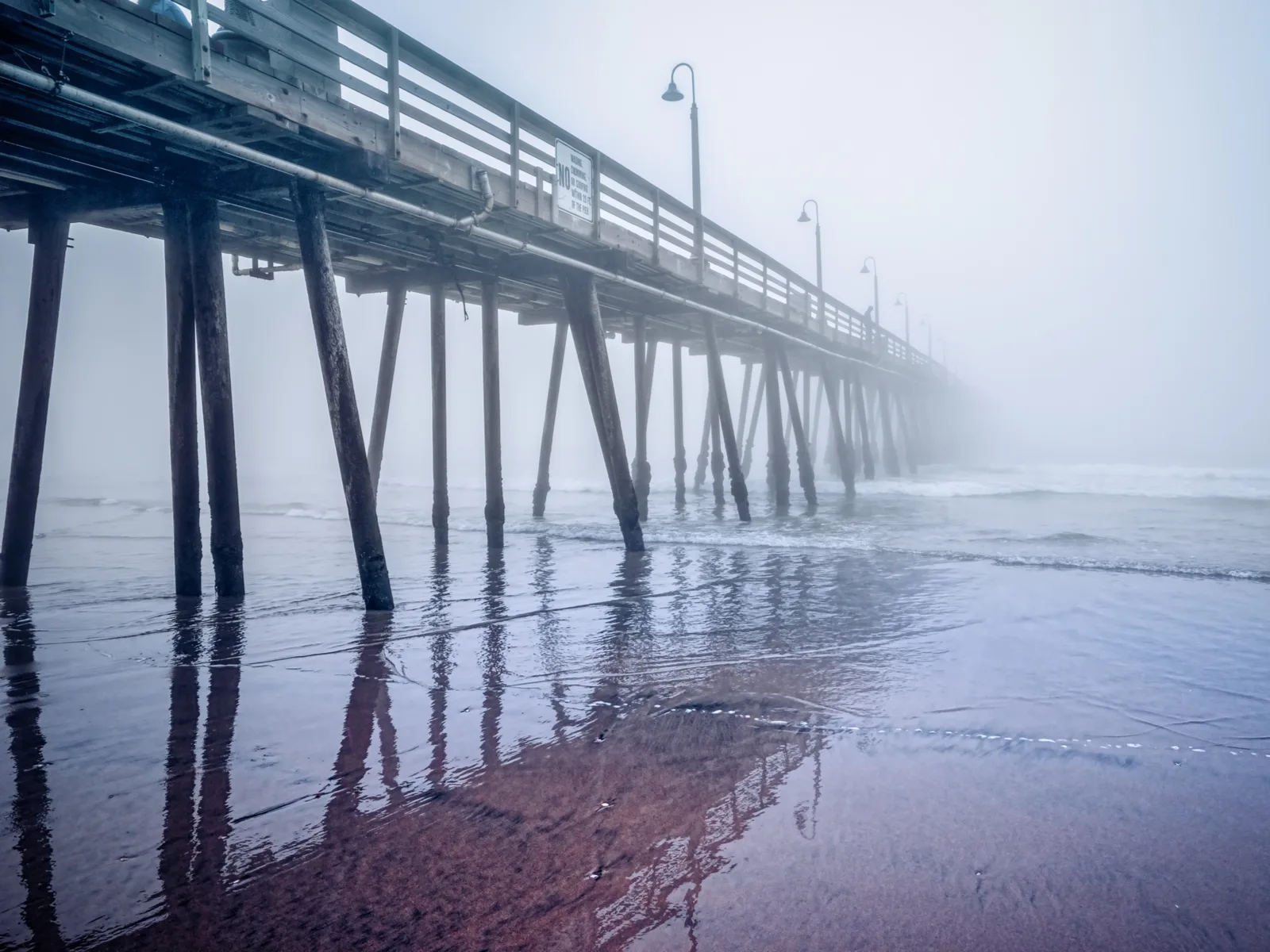 Very foggy pier pictured during the worst time to visit San Diego