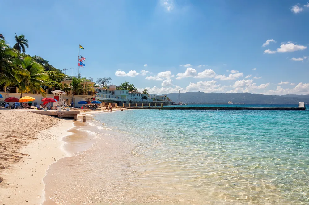 Postcard-worthy beach in Montego Bay with blue skies above the still water, pictured for a guide to the best time to visit Jamaica