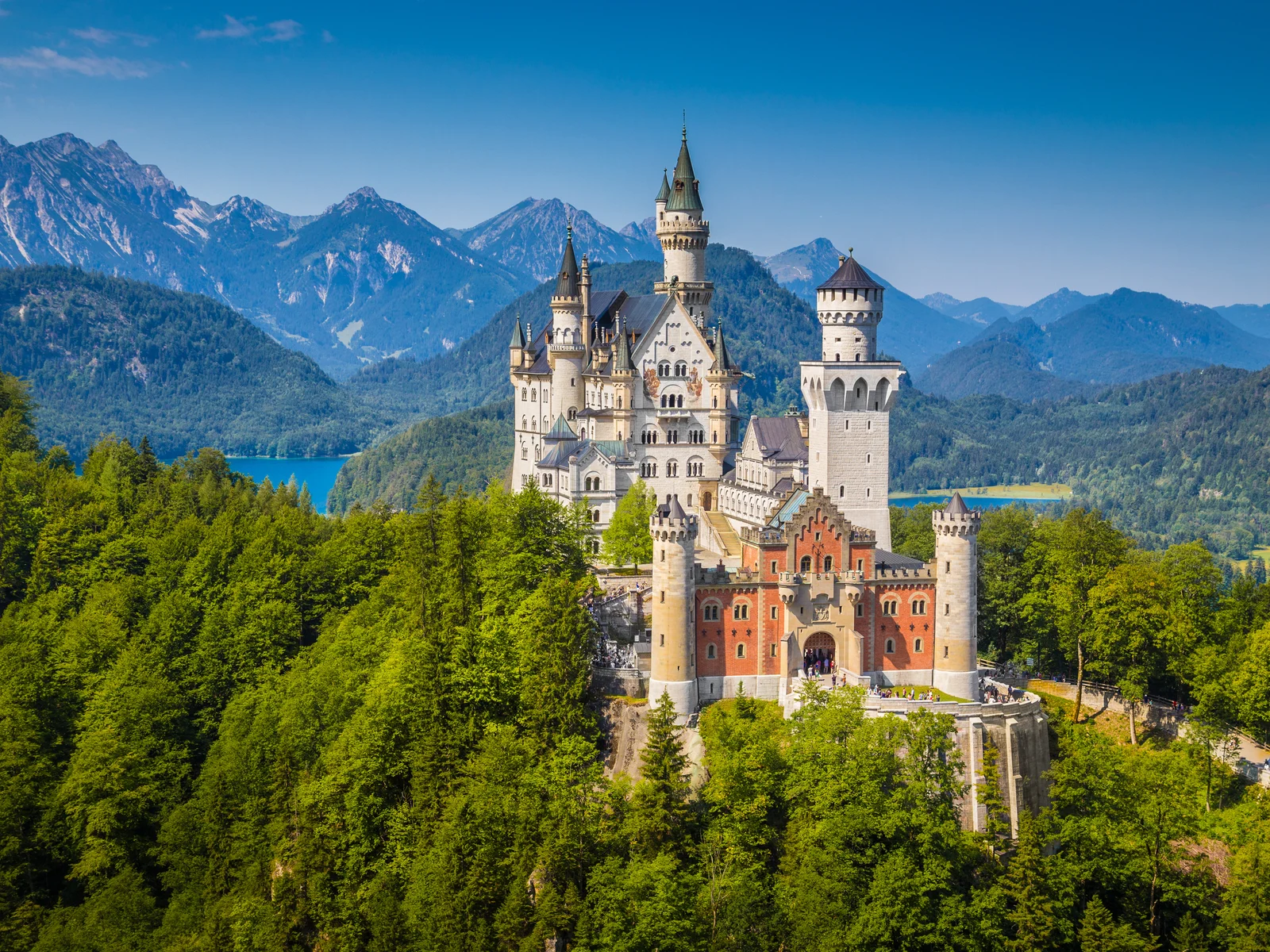 Neuschwanstein Castle against a mountain landscape during the best time to visit Germany