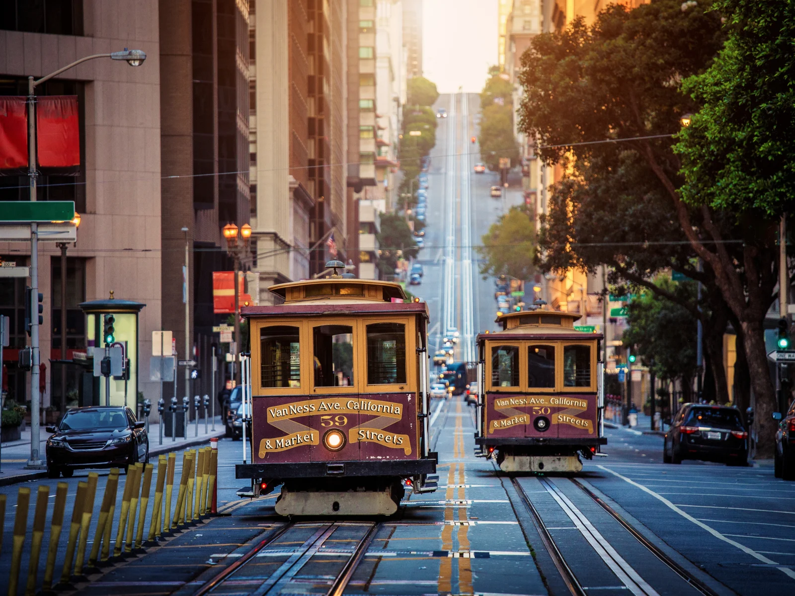 Traditional cable cars going up California Street during the best time to go to San Francisco