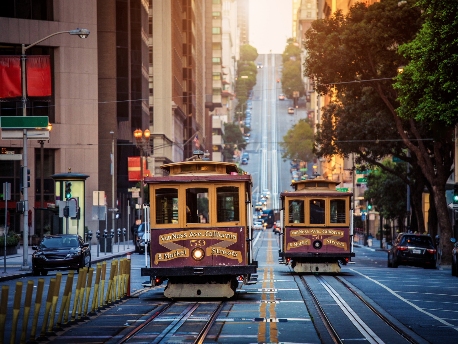 Cable cars being pulled up a steep hill on California Street for a piece titled Is San Francisco Safe