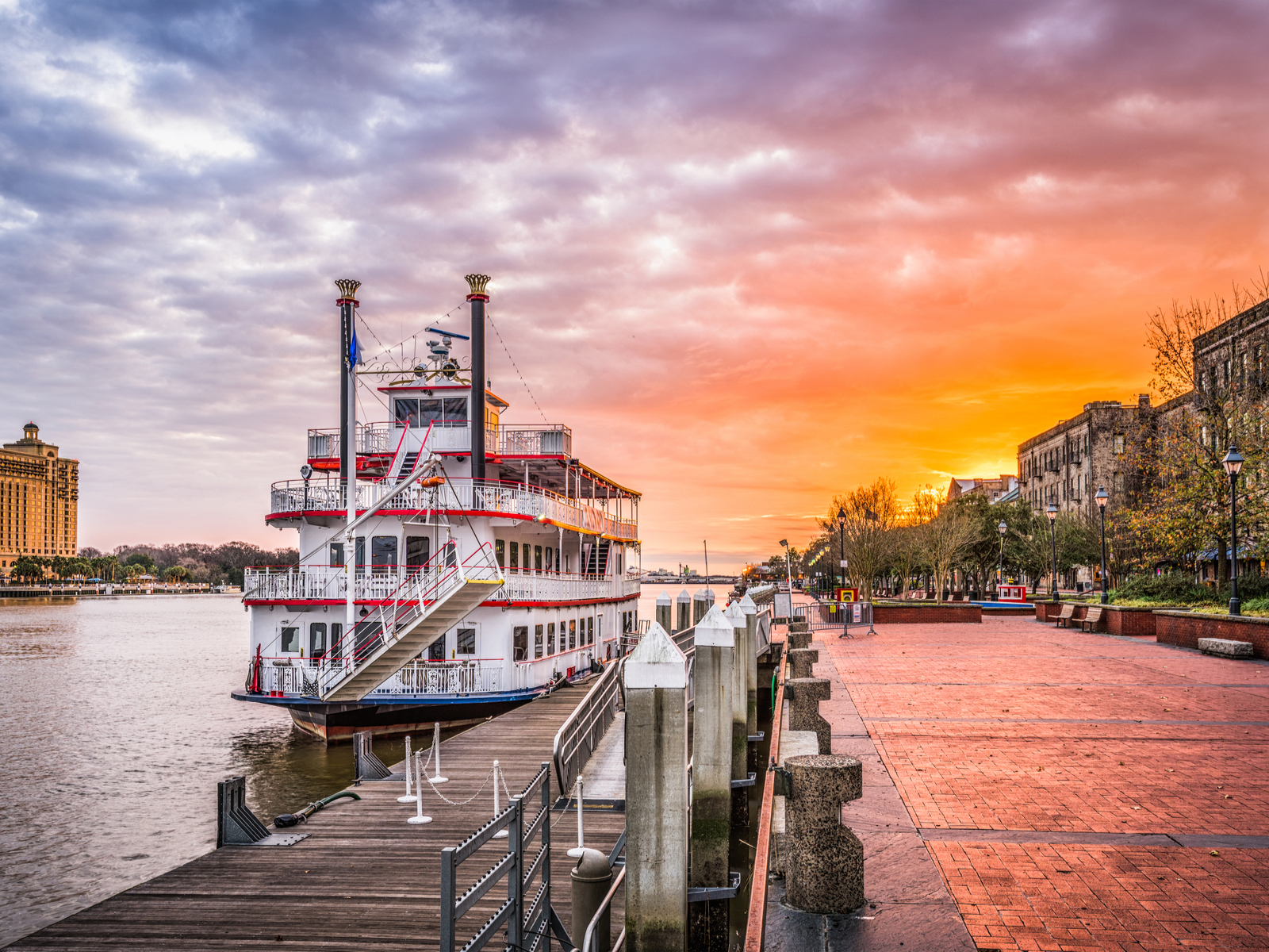 Barge on the river outside the promenade at dusk during the best time to visit Savannah GA
