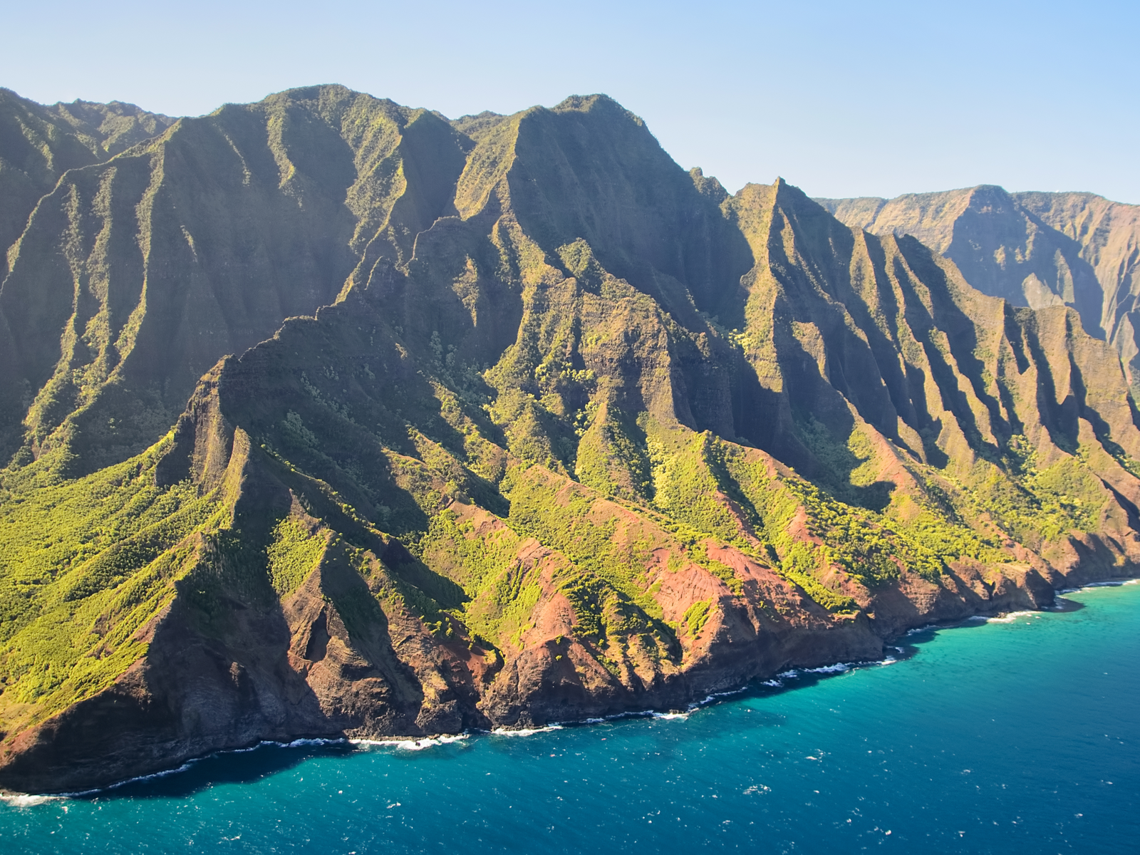 Unique land formation with patches of greeneries at Napali Coast State Wilderness Park in Hawaii, one of the most beautiful places in the US
