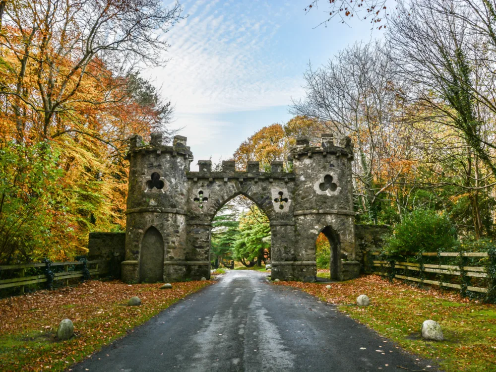 A medieval arch gate on a bright Autumn at Tollymore Forest Park in Northern Ireland, a piece on Game of Thrones filming locations you can visit