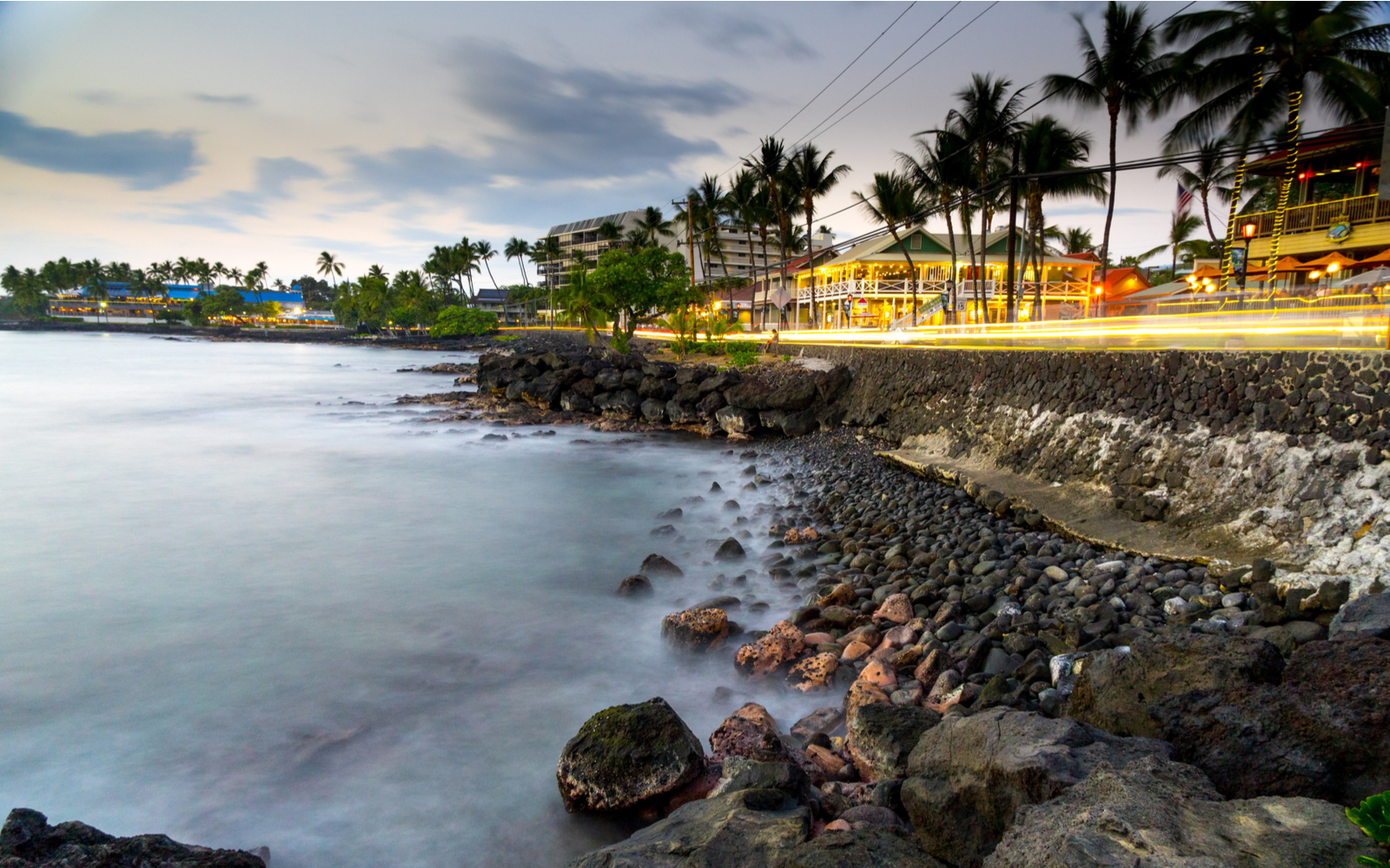Featured image of the Kona coastline with a rocky dropoff featuring the best hotels in Kona in frame
