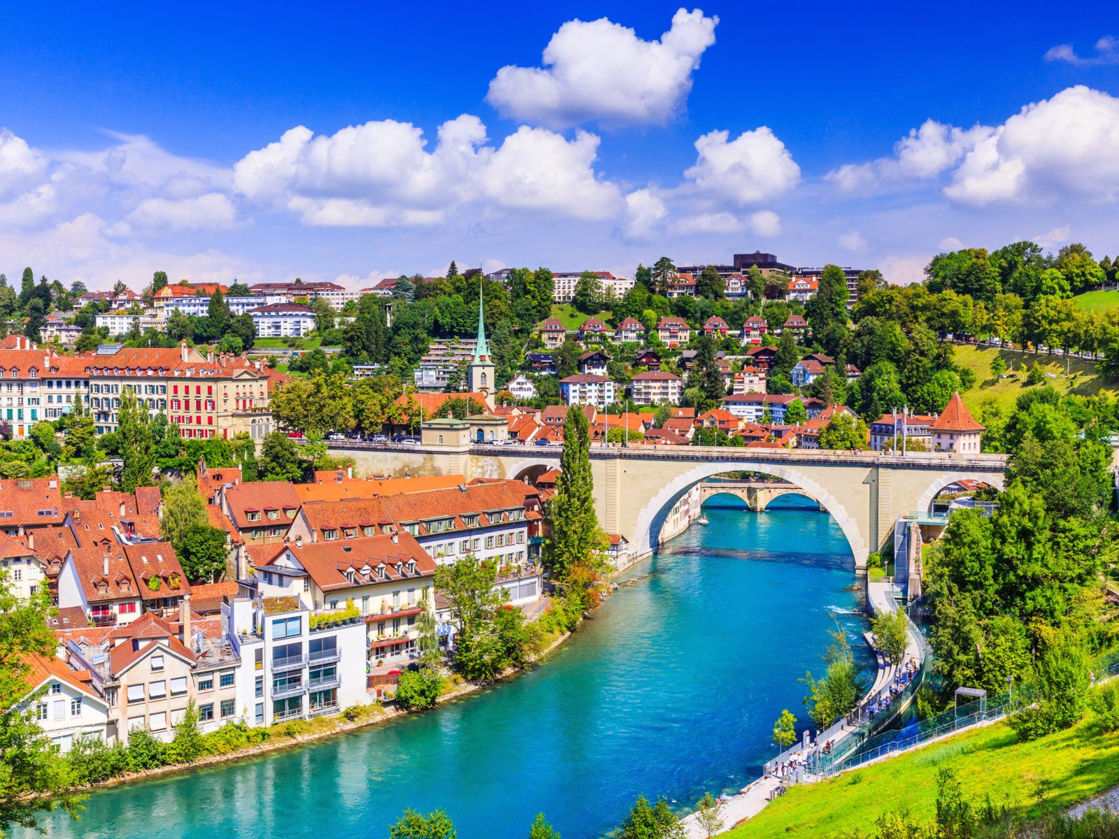 Bern, an old city center with a stone bridge and homes along the river, for a piece on the best time to go to Switzerland