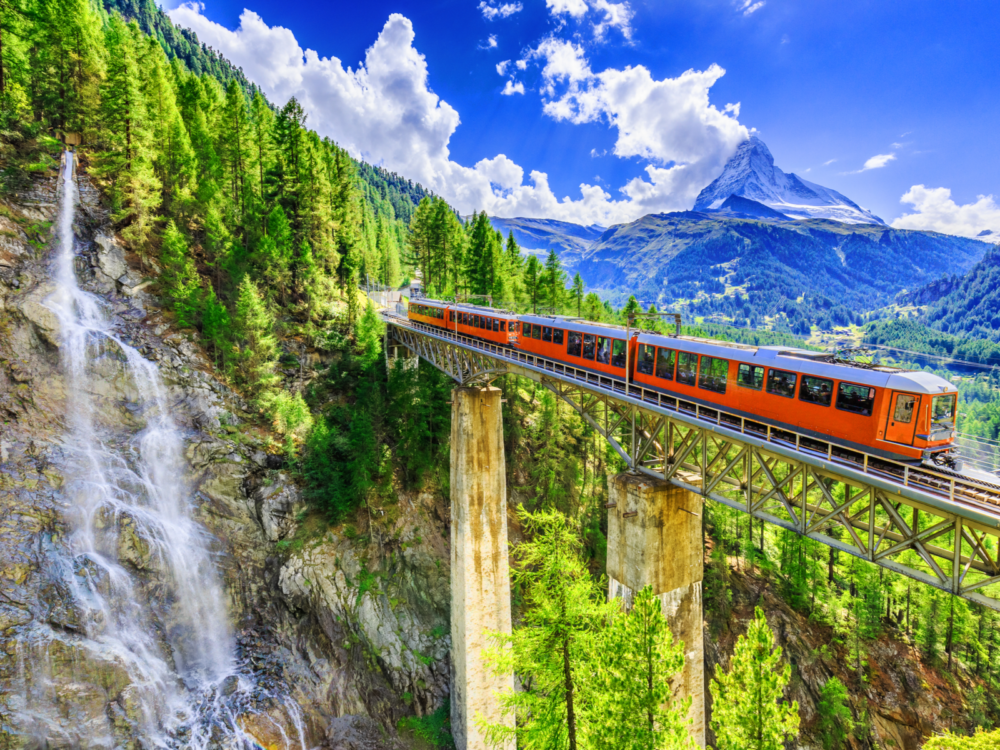Zermatt with a tourist train spanning a gorge in the Swiss Alps
