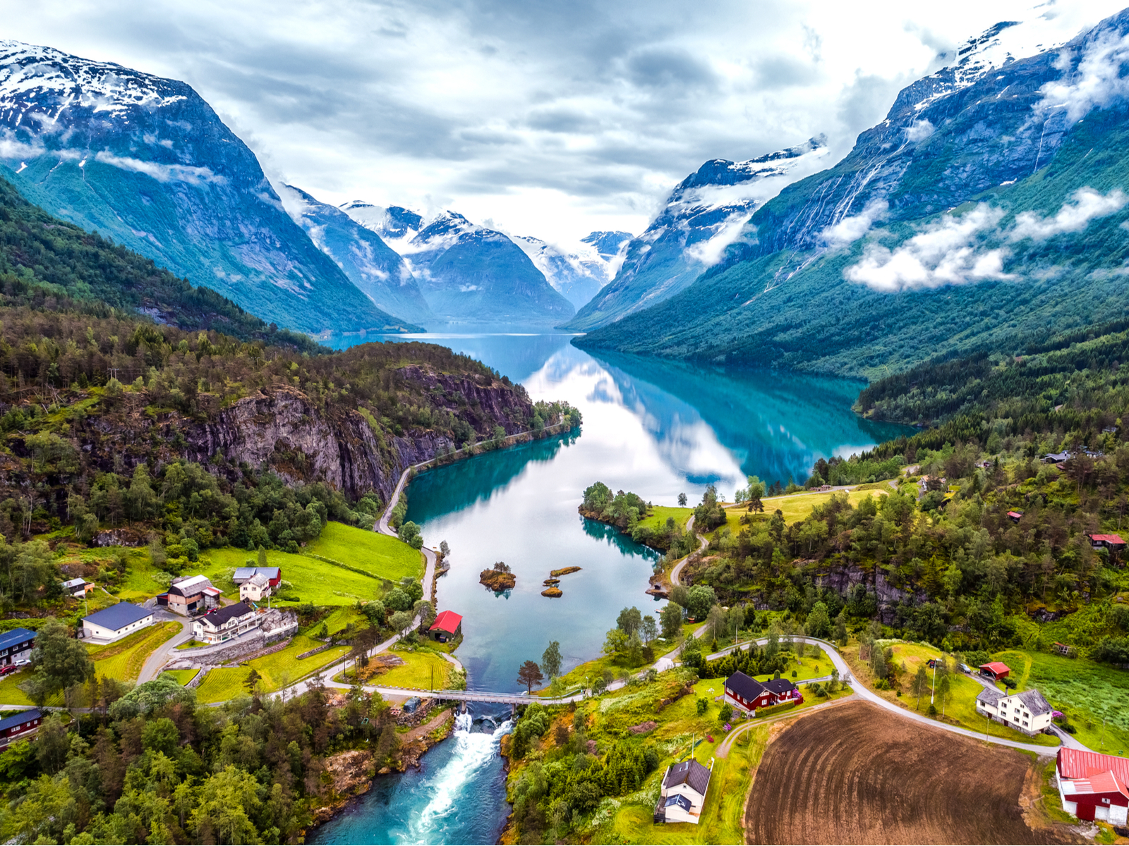 Aerial shot of the beautiful countryside, mountains, and river for a piece on the best time to visit Norway