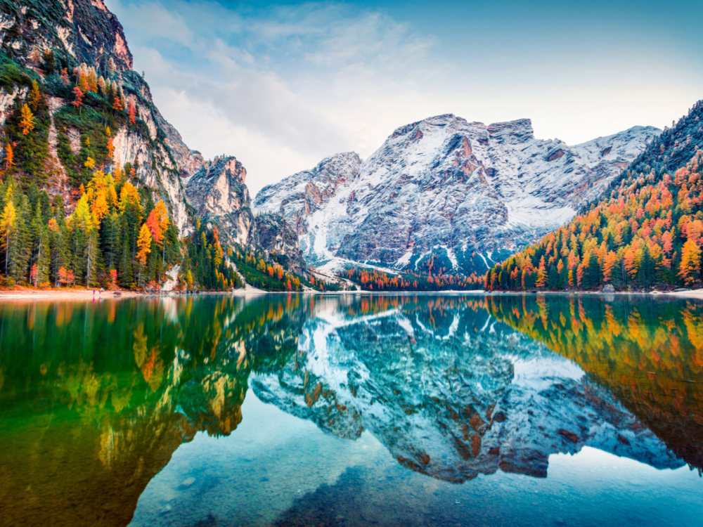 Gorgeous view taken during the cheapest time to visit Europe picturing Braies Lake in the Dolomites